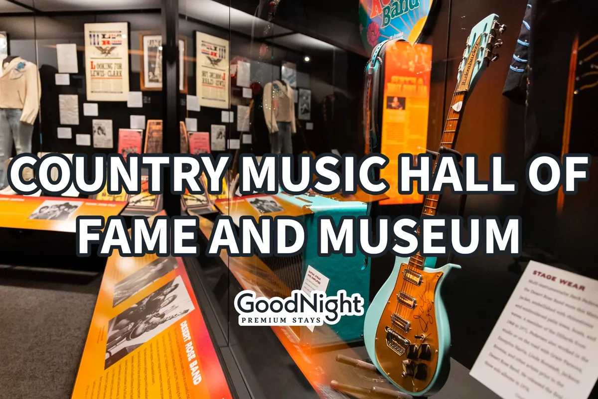 An interior shot of the Country Music Hall of Fame, featuring iconic guitars, stage outfits, and historic memorabilia displayed for visitors. The space is illuminated and exudes an atmosphere of cultural celebration.